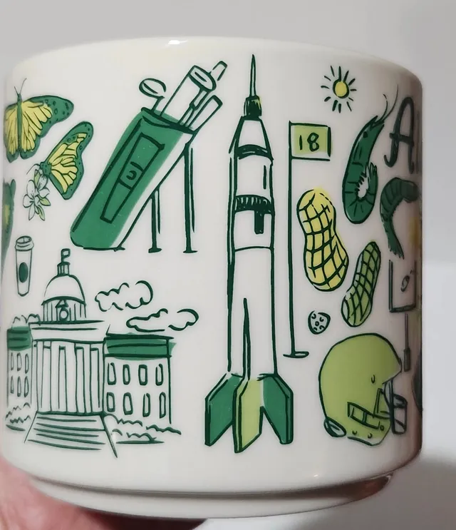 Starbucks Been There Series Alabama mug with Alabama in green script, a waterfall, camellia blossoms, a football and a black bear on the back — side view