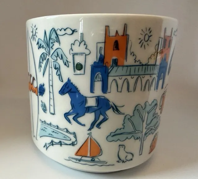 Starbucks Been There Series San Diego mug with San Diego in blue script, a bicycle, a beer glass, a taco and a blue horse — side view