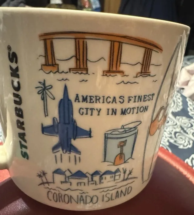 Starbucks Been There Series San Diego mug with San Diego in blue script, a bicycle, a beer glass, a taco and a blue horse — back view