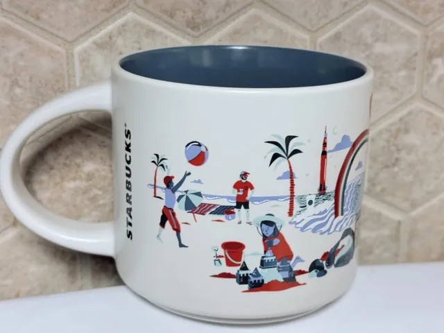 Starbucks Discovery Series Alabama mug with guitars, red camellias, red berries, a red propeller plane and a waterfall around the word ALABAMA — back view