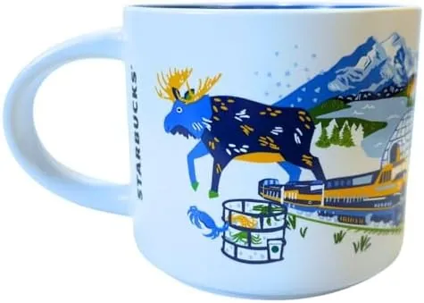 Starbucks Discovery Series Alaska mug with sled dogs, a floatplane, an eagle and blue flowers around the word ALASKA — back view