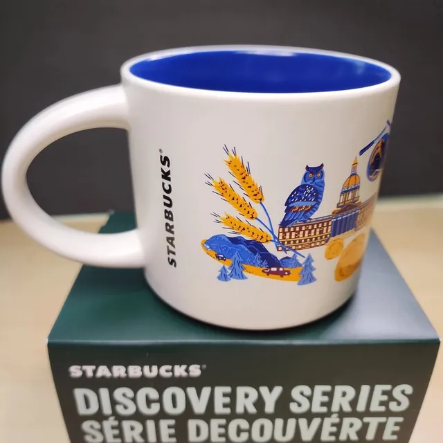 Starbucks Discovery Series Alberta mug with purple flowers, a blue bison, beehive boxes and a stepped waterfall around the word ALBERTA — back view