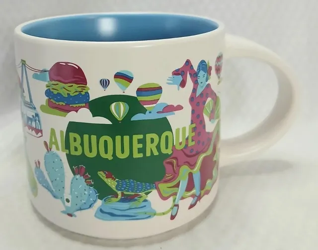 Starbucks Discovery Series Albuquerque mug with hot air balloons, a lizard, a prickly pear cactus and a dancer around the word ALBUQUERQUE