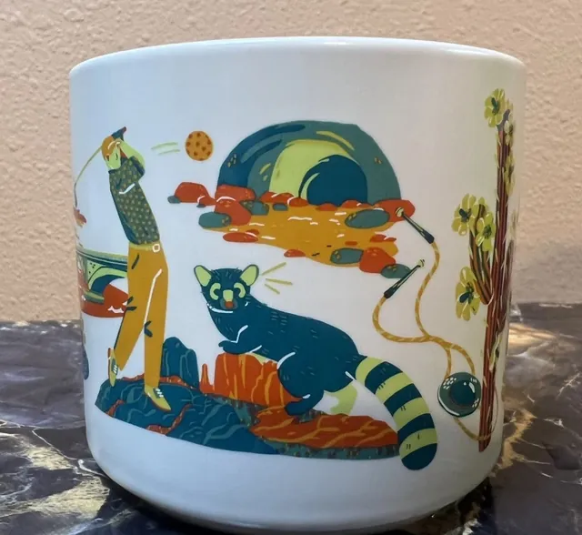 Starbucks Discovery Series Arizona mug with a lizard, hot air balloons, a scorpion and a canyon around the word ARIZONA — back view
