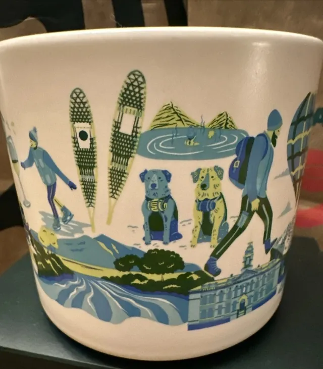 Starbucks Discovery Series Aspen mug with ski gondolas, a hot air balloon and snowy mountains around the word ASPEN — side view