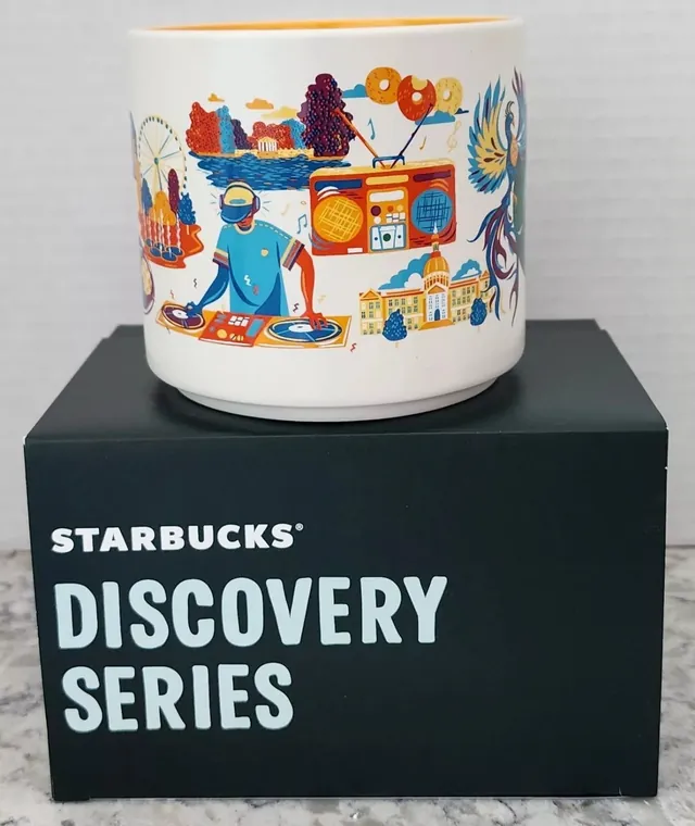 Starbucks Discovery Series Atlanta mug with a phoenix, a skyline, a stadium and a race car around the word ATLANTA — side view