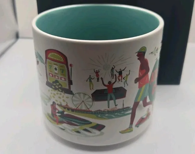 Starbucks Discovery Series Atlantic City mug in its box with a runner, jets, a whale and boardwalk storefronts around the word ATLANTIC CITY — side view