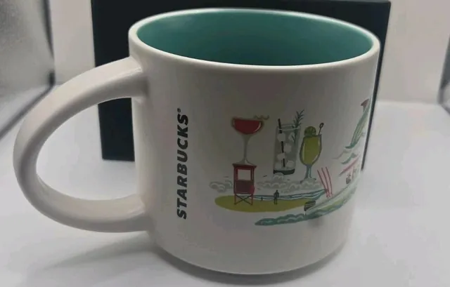 Starbucks Discovery Series Atlantic City mug in its box with a runner, jets, a whale and boardwalk storefronts around the word ATLANTIC CITY — back view