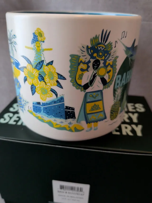 Starbucks Discovery Series Bahamas mug in its trilingual box with a marlin, a pineapple, sailboats and a costumed dancer around the word BAHAMAS — side view