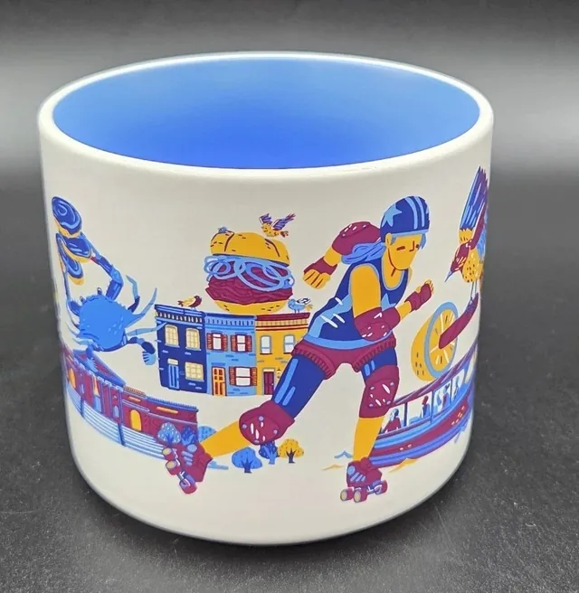 Starbucks Discovery Series Baltimore mug with a bird, a paddle boat and a ship around the word BALTIMORE and a blue inside — side view