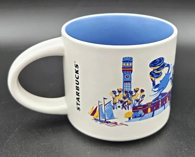 Starbucks Discovery Series Baltimore mug with a bird, a paddle boat and a ship around the word BALTIMORE and a blue inside — back view