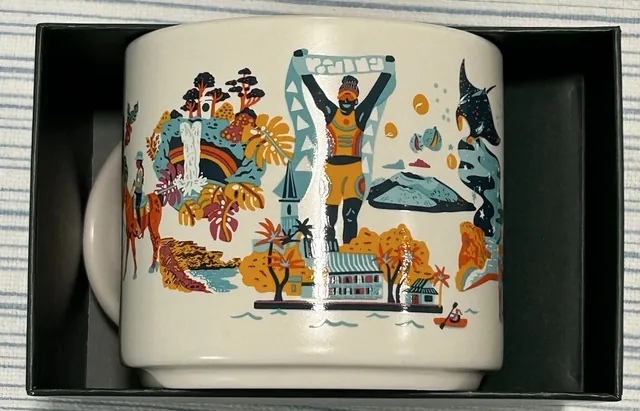 Starbucks Discovery Series Big Island mug with a scuba diver, red coral and a rainbow around the words BIG ISLAND — side view