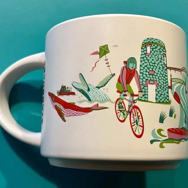 Starbucks Discovery Series Cape Cod mug with a green shingled house, hydrangeas, oysters and a gull around the words CAPE COD — back view