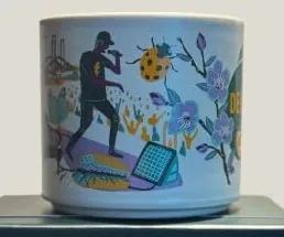 Starbucks Discovery Series Delaware mug with dolphins, purple blossoms and desserts around the word DELAWARE — side view
