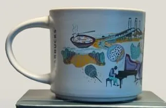 Starbucks Discovery Series Delaware mug with dolphins, purple blossoms and desserts around the word DELAWARE — back view