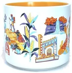 Starbucks Discovery Series Illinois mug with pumpkins, an orange fish, a deer at an easel and a canoe around the word ILLINOIS — side view