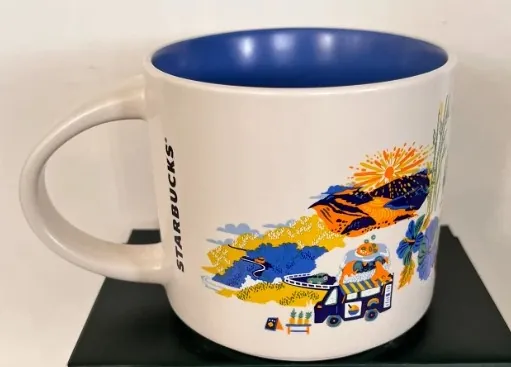 Starbucks Discovery Series Maui mug with a surfer on a wave, a pineapple, a seal and a waterfall around the word MAUI — back view