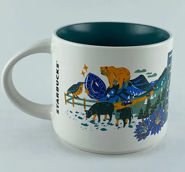 Starbucks Discovery Series Montana mug with huckleberries, an eagle, a lake, a campfire and mountains around the word MONTANA — back view