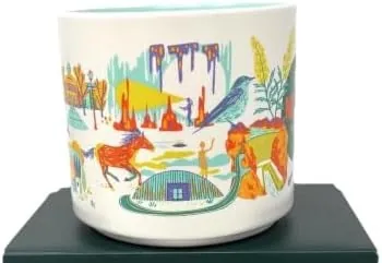 Starbucks Discovery Series Nevada mug with a dragonfly, a craps table and dice, a platter of food and an erupting mound around the word NEVADA — side view