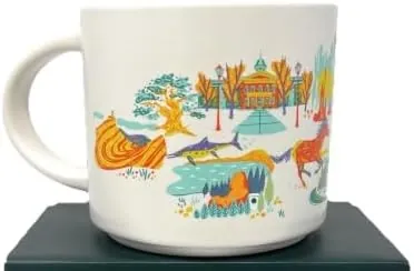 Starbucks Discovery Series Nevada mug with a dragonfly, a craps table and dice, a platter of food and an erupting mound around the word NEVADA — back view