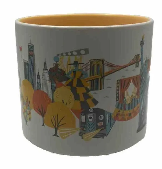 Starbucks Discovery Series New York City mug with a yellow taxi, a pigeon, a pizza slice, an apple and the Statue of Liberty around the words NEW YORK CITY — side view