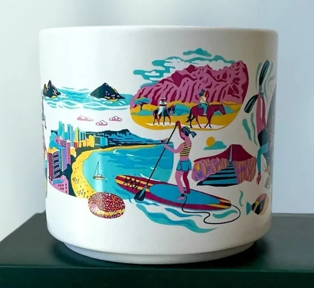 Starbucks Discovery Series Oahu mug with a plumeria flower, snorkeler and surfboards around the word OAHU — side view