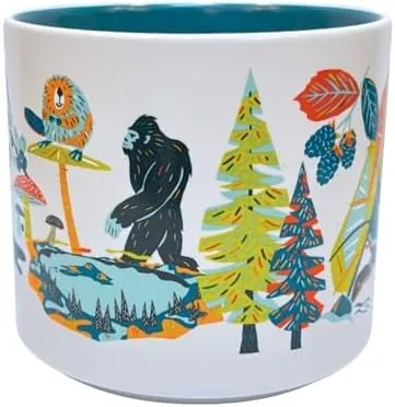 Starbucks Discovery Series Oregon mug with a duck, a windsurfer, a sea stack, berries and tulips around the word OREGON — side view