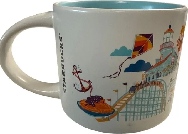 Starbucks Discovery Series San Diego mug with a roller skater, sea lion, orange fish, taco, palm trees and lifeguard tower around the words SAN DIEGO — back view