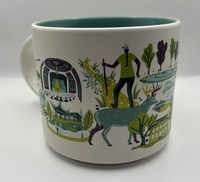 Starbucks Discovery Series Staten Island mug with a sea turtle, a suspension bridge, a ferry and a lobster around the words STATEN ISLAND — side view
