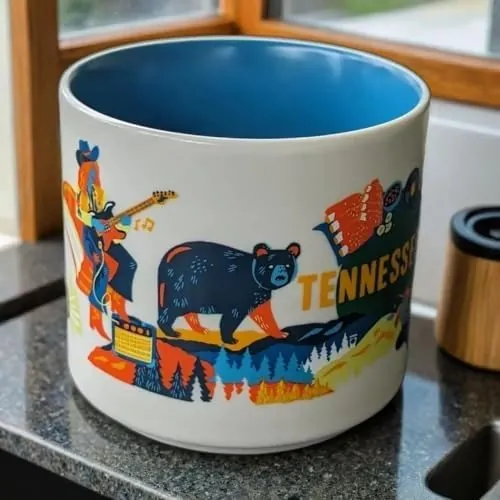 Starbucks Discovery Series Tennessee mug with a black bear, vinyl records, a rack of ribs and a waterfall around the word TENNESSEE — side view