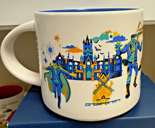 Starbucks Discovery Series Universal Epic Universe mug with two dragons, an orange creature and teal lettering over a green circle — back view