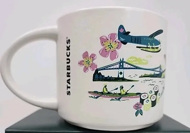 Starbucks Discovery Series Vancouver mug with orcas, a film camera, a skyline and waterbirds around the word VANCOUVER — back view