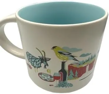 Starbucks Discovery Series Washington mug with a salmon, a red apple, a snowy mountain and a Bigfoot-style figure around the word WASHINGTON — back view