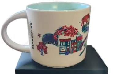 Starbucks Discovery Series Washington, D.C. mug with fireworks, a kayaker, a white columned building and a blue bird around the name — back view
