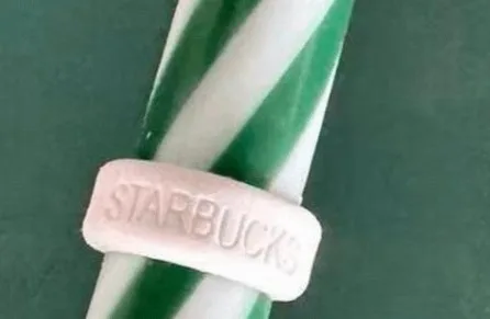 Close-up of a white straw ring with 'STARBUCKS' embossed in it.