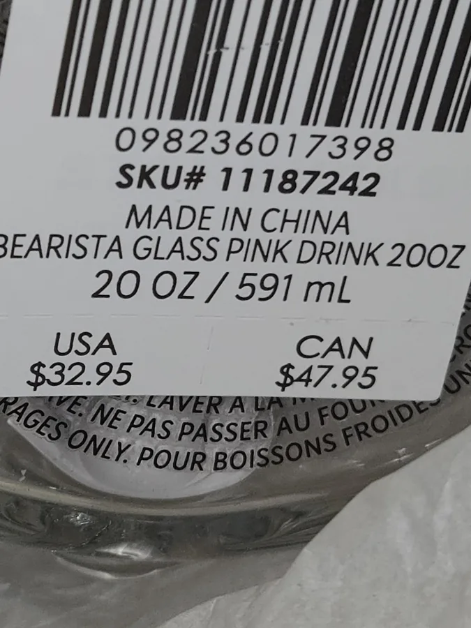 Close-up of a base sticker: SKU# 11187242, MADE IN CHINA, BEARISTA GLASS PINK DRINK 20OZ, 20 OZ / 591 mL, USA $32.95, CAN $47.95.