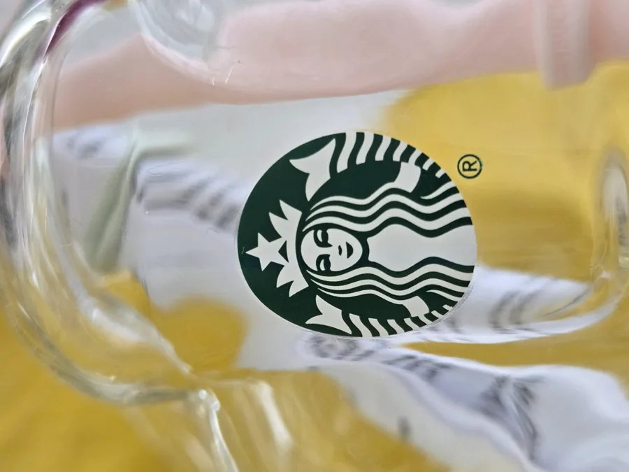 Close-up of the siren logo on the glass with the registered mark.