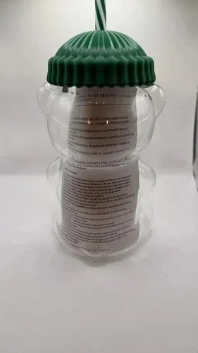 Starbucks Bearista original glass cold cup, a bear-shaped glass cup with a green ribbed beanie lid and a striped straw, back view