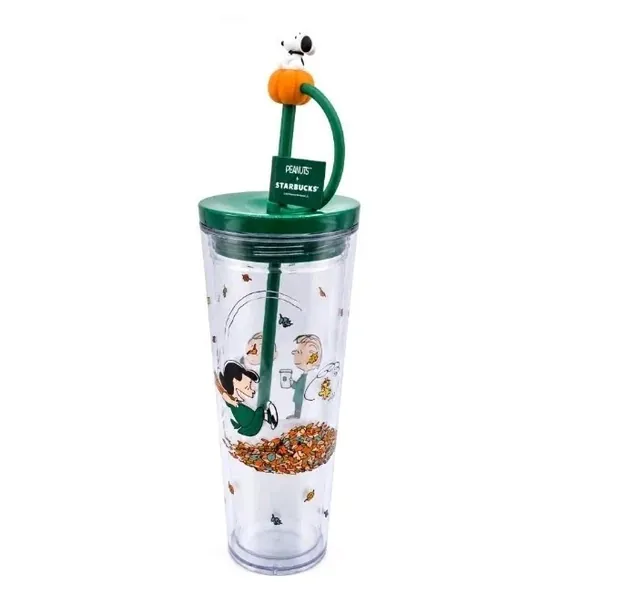 Starbucks Peanuts 24 oz clear cold cup with Charlie Brown and Linus among fall leaves and a Snoopy-on-a-pumpkin straw topper, back view