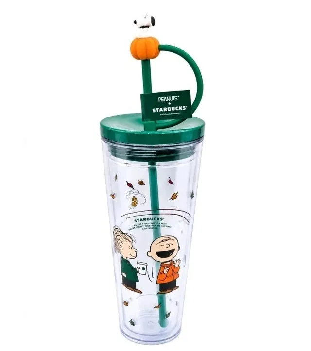Starbucks Peanuts 24 oz clear cold cup with Charlie Brown and Linus among fall leaves and a Snoopy-on-a-pumpkin straw topper