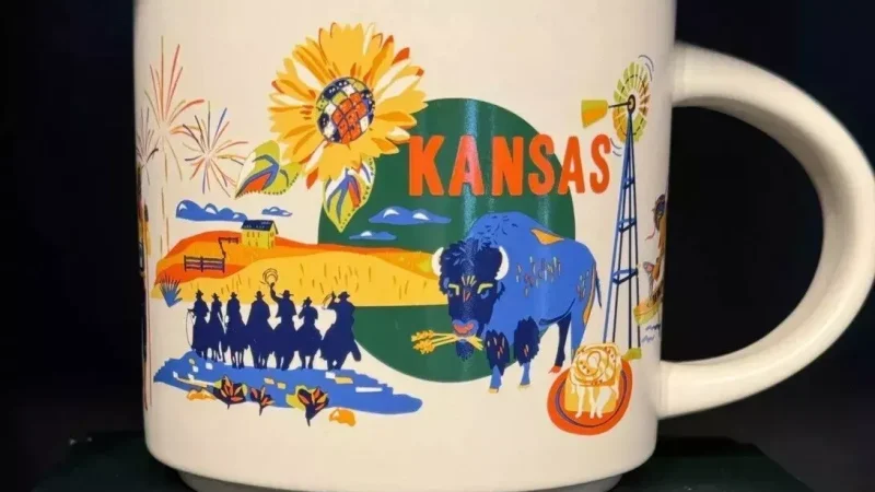 Kansas Starbucks mug displaying a sunflower, bison, windmill, cowboy scene, and prairie landscape.