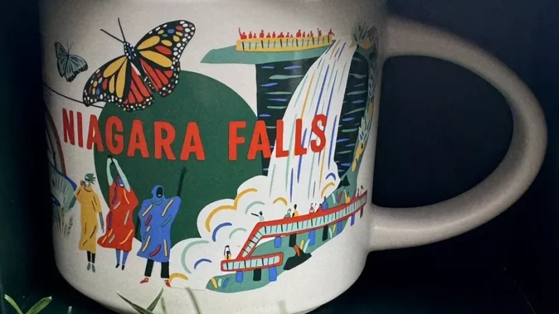 Niagara Falls Starbucks mug displaying a waterfall, rainbow, butterflies, city skyline, and gambling chips.