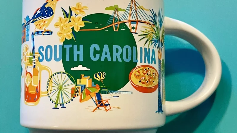 South Carolina Starbucks mug displaying a beach scene, lighthouse, musical notes, and a bird.