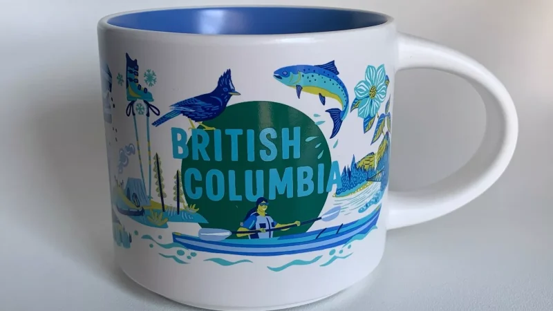 British Columbia Starbucks mug showing a person kayaking, surrounded by wildlife, mountains, forests, and winter sports symbols.