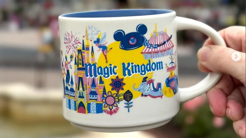 Magic Kingdom Starbucks mug in front of the magic kingdom castle