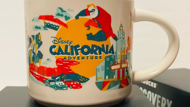 Disney California Adventure Starbucks Discovery Series Mug showcasing Mickey Mouse Ferris wheel, Mr. Incredible, Lightning McQueen, and Grizzly Peak attractions in vibrant colors