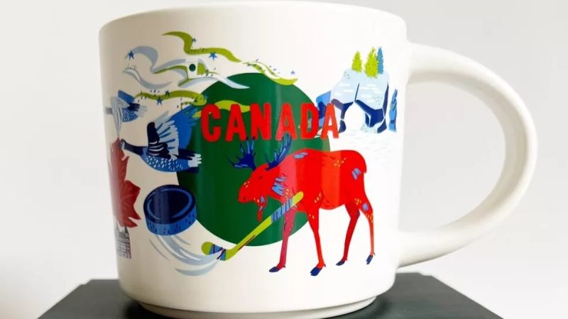 Canada Starbucks mug with illustrations of a moose playing hockey, Canadian geese, snowy mountains, and pine trees.