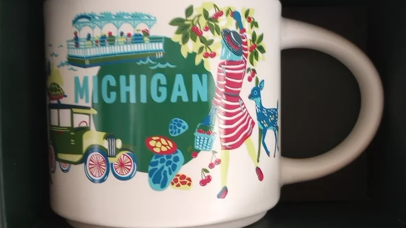 Michigan Starbucks mug with images of cherries, Great Lakes, vintage car, blue deer, and pavilion.