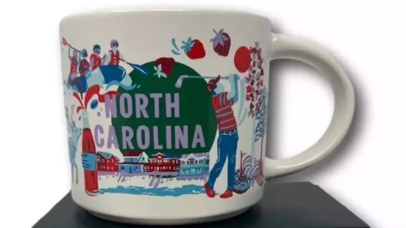 North Carolina Starbucks mug with images of a golfer, lighthouse, cardinal, deer, and outdoor activities.