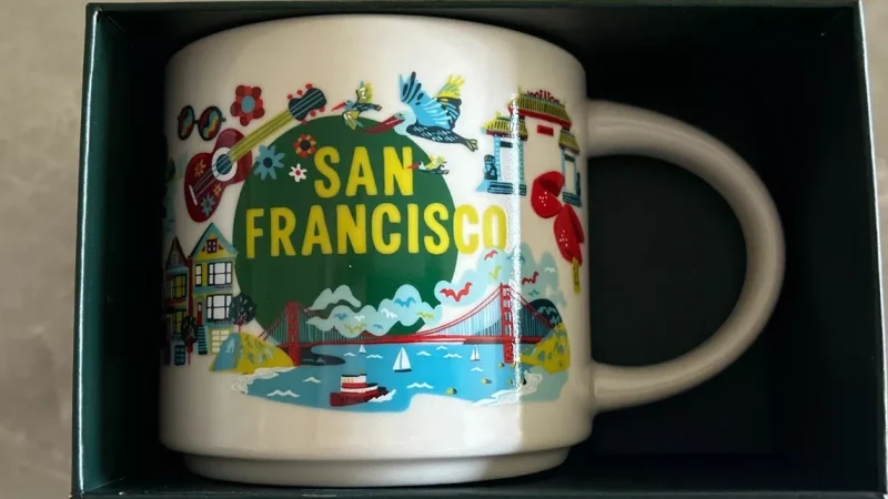 San Francisco Starbucks mug with images of the Golden Gate Bridge, cable car, row houses, and bowl of Asian cuisine.